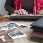 person-looking-through-old-photographs-and-memorie-web