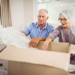 senior-couple-unpacking-belongings-after-moving-ho-web